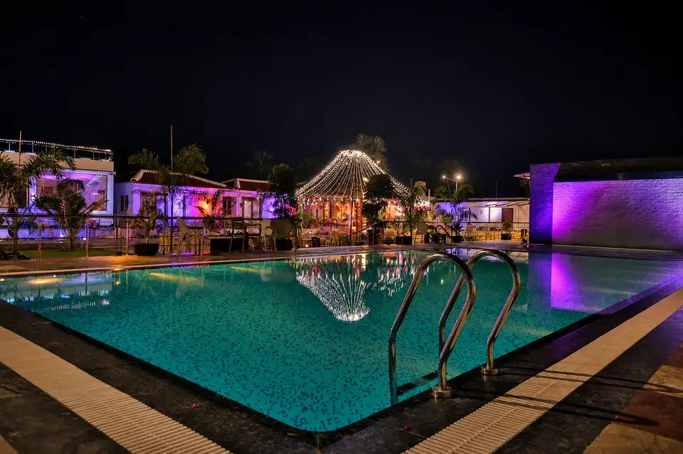 Swimming pool at MYRA Golden Beach Resort at night